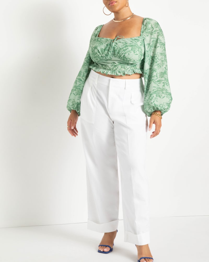 Front of a model wearing a size 14 Muranda Patch Pocket Trouser in Soft White by ELOQUII. | dia_product_style_image_id:228482